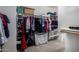 Walk-in closet featuring shelving, ample hanging space, and carpeted floors at 3065 E Harvard Ave, Gilbert, AZ 85234