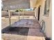 Covered back patio featuring tiled flooring, a hose, and a view of the gravel backyard at 3121 W Laurie Ln, Phoenix, AZ 85051