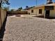 Gravel backyard with a built-in fire pit and view of the fenced perimeter at 3121 W Laurie Ln, Phoenix, AZ 85051