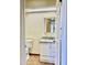 Clean bathroom with a white vanity, granite countertop, and a decorative mirror at 3121 W Laurie Ln, Phoenix, AZ 85051