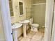 Bathroom showcasing dual pedestal sinks, tiled flooring, and a glass-enclosed shower stall at 3121 W Laurie Ln, Phoenix, AZ 85051