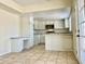 Well-lit kitchen with white cabinetry, granite counters, stainless appliances, and a built-in desk at 3121 W Laurie Ln, Phoenix, AZ 85051