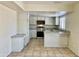 Bright kitchen boasts white cabinets, granite countertops, and stainless steel appliances at 3121 W Laurie Ln, Phoenix, AZ 85051