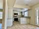 Open kitchen features granite counters, stainless appliances, and white cabinetry at 3121 W Laurie Ln, Phoenix, AZ 85051