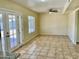 Spacious living area features a ceiling fan, tile flooring, and access to an outdoor patio at 3121 W Laurie Ln, Phoenix, AZ 85051
