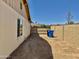 Side yard with a view of the neighborhood, a gate, and blue trash cans at 3121 W Laurie Ln, Phoenix, AZ 85051