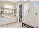 Primary bathroom with double sinks, granite countertops, a walk-in shower, and neutral tile flooring at 31320 N 54Th Pl, Cave Creek, AZ 85331