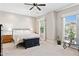 Spacious primary bedroom with a decorative chest, neutral walls, and natural light from large windows at 31320 N 54Th Pl, Cave Creek, AZ 85331