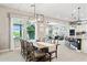 Open dining room with view to the kitchen, living room, and large windows at 31320 N 54Th Pl, Cave Creek, AZ 85331