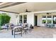 Covered patio with comfortable seating, ceiling fans, and travertine flooring overlooking the backyard at 31320 N 54Th Pl, Cave Creek, AZ 85331