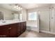 Primary bathroom features a double sink vanity with shower and bathtub at 3449 E Sheffield Rd, Gilbert, AZ 85296