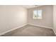 Cozy bedroom showcasing plush carpet, neutral walls, and a window at 3449 E Sheffield Rd, Gilbert, AZ 85296