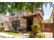 Inviting tan two-story home with lush green lawn and manicured bushes at 3449 E Sheffield Rd, Gilbert, AZ 85296