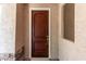 Close-up of a dark wood front door with white trim on a tan home at 3449 E Sheffield Rd, Gilbert, AZ 85296