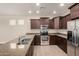 Bright kitchen with stainless steel appliances, granite countertops, and wood cabinets at 3449 E Sheffield Rd, Gilbert, AZ 85296