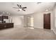 Open-concept living room features tile flooring, a ceiling fan, and natural light at 3449 E Sheffield Rd, Gilbert, AZ 85296