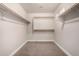 Empty walk-in closet with carpet, shelves and hanging racks at 3449 E Sheffield Rd, Gilbert, AZ 85296