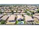 Overhead shot of a vibrant neighborhood with lush landscaping, showcasing homes with backyard pools and ample street parking at 3668 E Derringer Way, Gilbert, AZ 85297