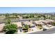 Aerial view of a well-maintained neighborhood showcasing mature trees and a home with a neat desert-style front yard at 3668 E Derringer Way, Gilbert, AZ 85297