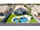 Aerial view of a backyard featuring a refreshing pool, manicured lawn, and a covered patio perfect for entertaining at 3668 E Derringer Way, Gilbert, AZ 85297
