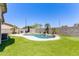 Spacious backyard features a pool with waterfall, patio area, and desert landscaping at 3668 E Derringer Way, Gilbert, AZ 85297