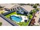 Aerial view shows a beautiful swimming pool, patio, and manicured lawn with mature plants at 3668 E Derringer Way, Gilbert, AZ 85297