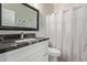 Modern bathroom features a black marble countertop and a white shower curtain at 3668 E Derringer Way, Gilbert, AZ 85297
