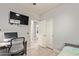 Bedroom featuring closet, mounted television, desk, chair, and nearby bathroom at 3668 E Derringer Way, Gilbert, AZ 85297