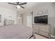 Large bedroom offering neutral tones, ceiling fan, and a dresser with television at 3668 E Derringer Way, Gilbert, AZ 85297