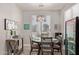 Charming dining area with a round table, industrial-style light fixture, and a beverage fridge at 3668 E Derringer Way, Gilbert, AZ 85297