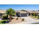 Charming home with xeriscaping, well-placed bushes, and a neat, clean driveway at 3668 E Derringer Way, Gilbert, AZ 85297