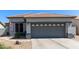Charming single-story home featuring a gray two-car garage and a well-maintained desert landscape at 3668 E Derringer Way, Gilbert, AZ 85297