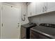 Clean laundry room with modern washer/dryer and ample white cabinet storage at 3668 E Derringer Way, Gilbert, AZ 85297