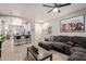 Stylish living area featuring a comfortable gray sectional couch and a bar-style kitchen island at 3668 E Derringer Way, Gilbert, AZ 85297