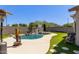 Beautiful backyard pool with rock waterfall feature and lush landscaping at 3668 E Derringer Way, Gilbert, AZ 85297