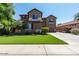 Charming two-story home featuring a well-manicured lawn and a long driveway leading to a two-car garage at 3693 E Sparrow Pl, Chandler, AZ 85286