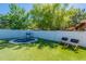 A backyard featuring a well maintained artificial turf, a basketball hoop and 2 chairs at 3931 E Weather Vane Rd, Gilbert, AZ 85296