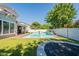 A lovely backyard with refreshing pool, ample lawn, and trampoline creates a perfect outdoor oasis at 3931 E Weather Vane Rd, Gilbert, AZ 85296