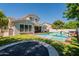 Beautiful backyard featuring a sparkling pool, lush green lawn, and fun trampoline for outdoor enjoyment at 3931 E Weather Vane Rd, Gilbert, AZ 85296