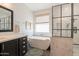 Bright bathroom with a standalone tub, walk-in shower, and luxurious marble countertops at 3931 E Weather Vane Rd, Gilbert, AZ 85296