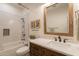 Charming bathroom with a wood-framed mirror, stylish tile accents, and a sleek vanity at 3931 E Weather Vane Rd, Gilbert, AZ 85296