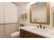 Tastefully designed bathroom featuring a tiled shower and tub combo, elegant vanity, and rustic mirror at 3931 E Weather Vane Rd, Gilbert, AZ 85296