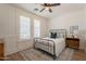 Serene bedroom with a metal frame bed, shuttered windows, and tasteful decor at 3931 E Weather Vane Rd, Gilbert, AZ 85296
