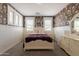 Charming bedroom features floral wallpaper, and an elegant vanity at 3931 E Weather Vane Rd, Gilbert, AZ 85296