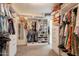 Walk-in closet with custom shelving, clothing racks, shoe storage, and drawers at 3931 E Weather Vane Rd, Gilbert, AZ 85296