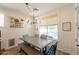 Bright dining room featuring a wooden table, bench seating, and natural light overlooking the pool at 3931 E Weather Vane Rd, Gilbert, AZ 85296