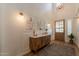 Bright entryway featuring a wooden console table, stylish decor, and a glimpse of the hardwood floors at 3931 E Weather Vane Rd, Gilbert, AZ 85296