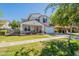 Inviting two-story home featuring a green lawn, charming front porch, and a lovely gray and white color scheme at 3931 E Weather Vane Rd, Gilbert, AZ 85296