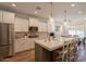 Bright kitchen features a center island with bar stool seating, modern appliances, and ample counter space at 3931 E Weather Vane Rd, Gilbert, AZ 85296
