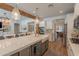 Open kitchen with island and sink provides connectivity to the fireplace and living room areas at 3931 E Weather Vane Rd, Gilbert, AZ 85296